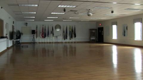 Banquet Room – open hall with wood floor and flag display